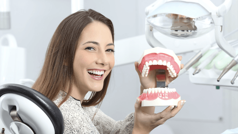 dentures high point | woman holding dentures
