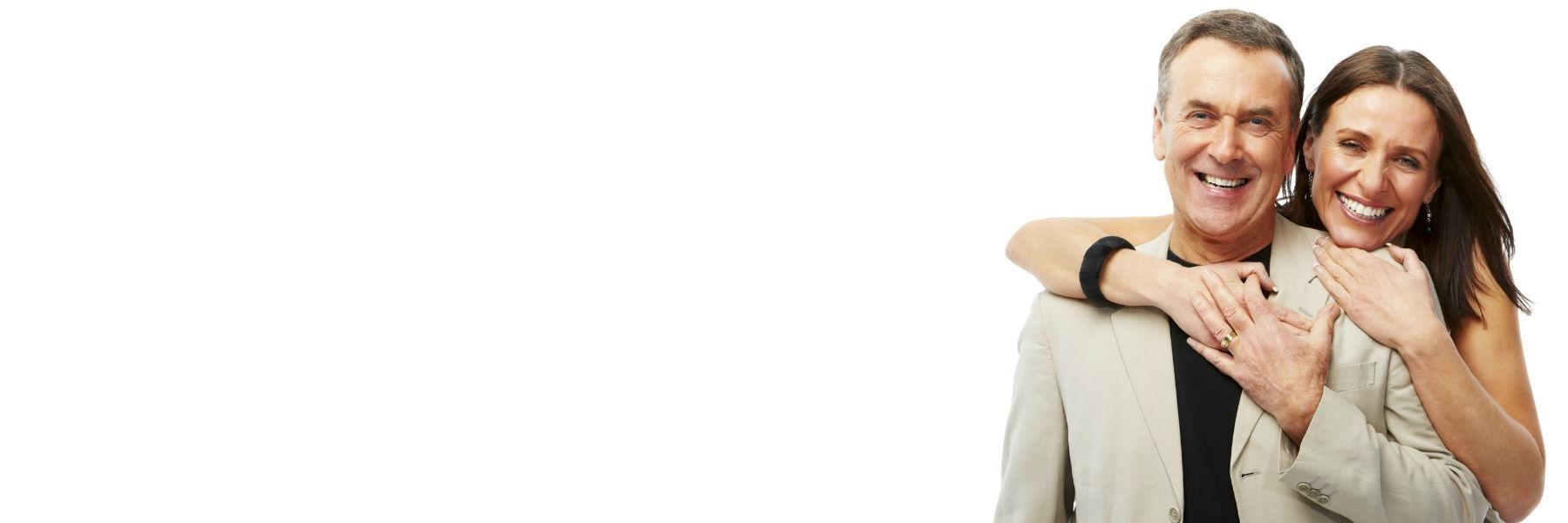 Elderly couple standing & smiling l cosmetic dentistry 27265