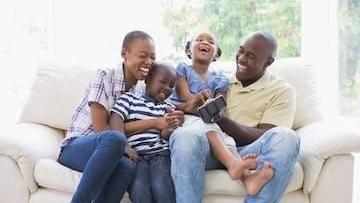 Man relaxing with his kids after family dentistry High Point, NC