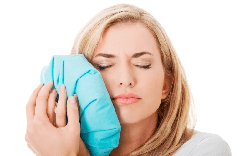 A patient holding her jaw due to toothache High Point, NC 