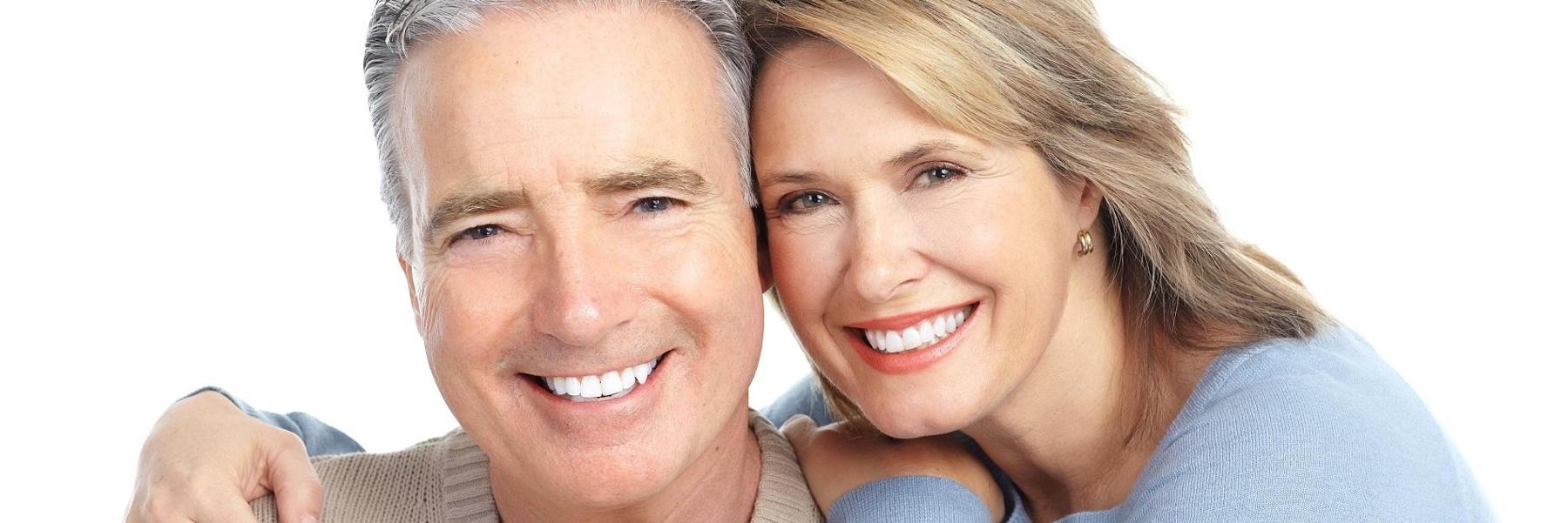 smiling couple with dental implants in high point nc